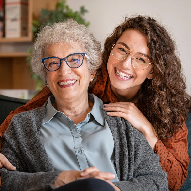 A mother and daughter embracing warmly, representing the family security that critical illness coverage provides