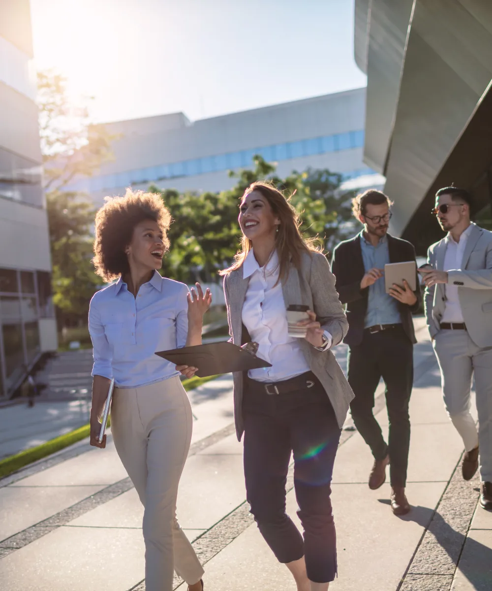 Financial professionals walking outside an office building, representing the career flexibility that IUL provides
