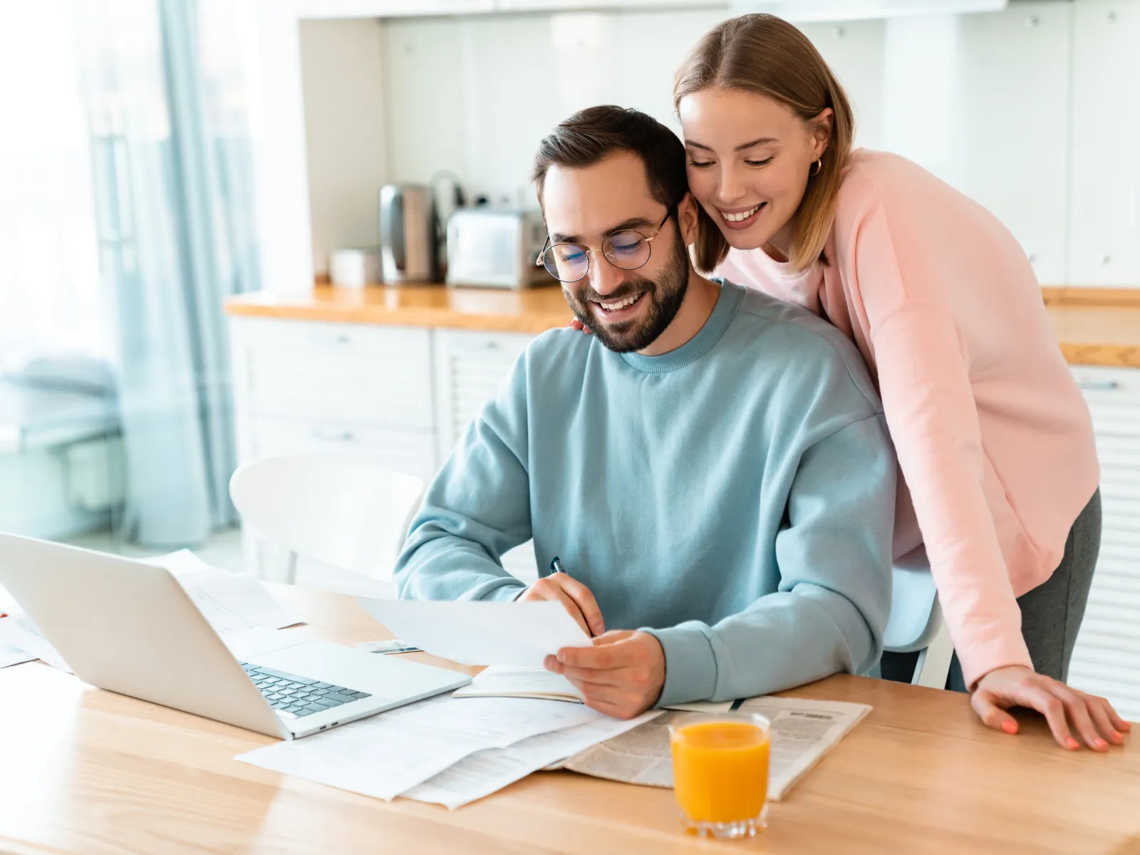 A couple reviewing their finances at the kitchen table