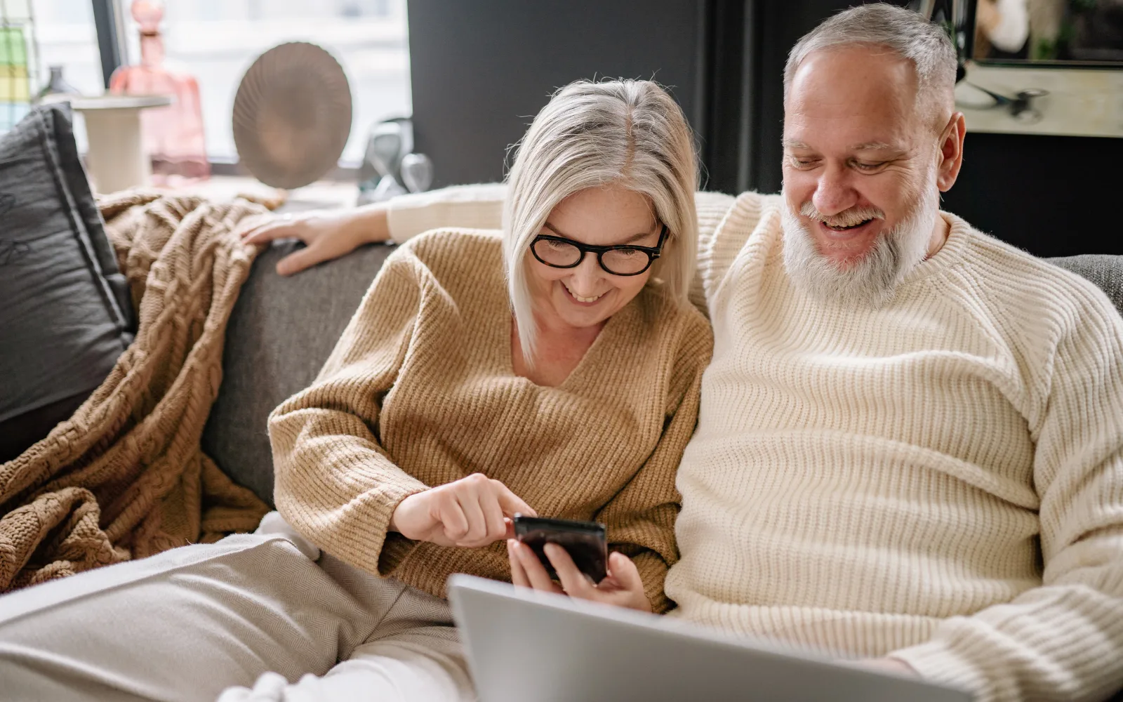 A retired couple enjoying a relaxed afternoon outdoors, representing the financial security and steady income of indexed annuities