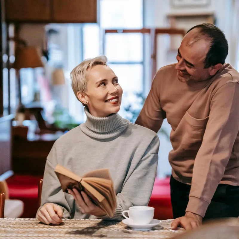 A couple relaxing at home, representing the financial security that critical illness coverage provides