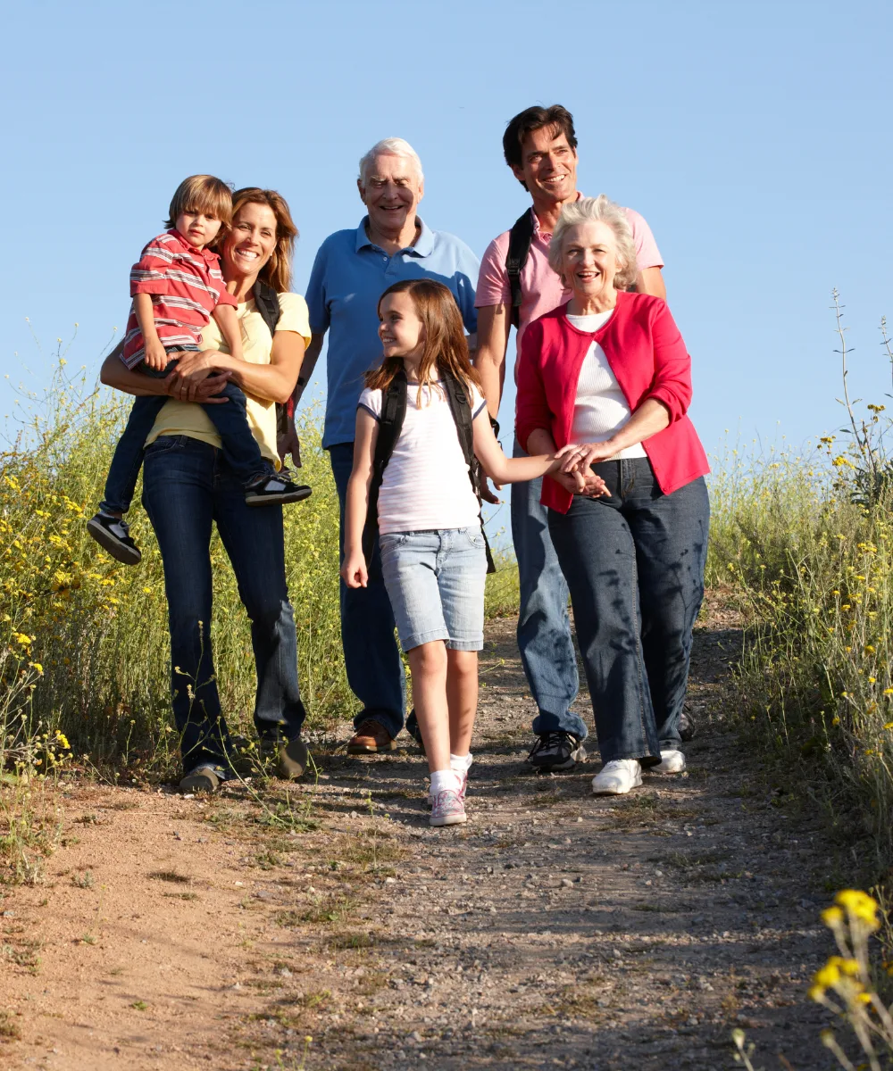 Three generations of a family walking together, representing the legacy and wealth transfer that whole life enables