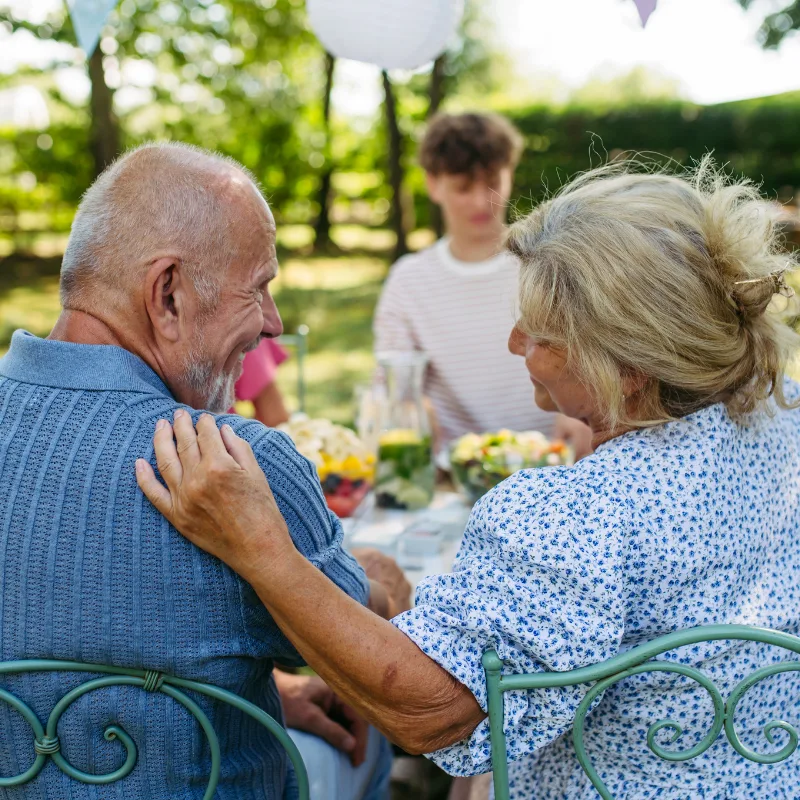 An older couple sharing a supportive moment, representing the protection that critical illness coverage provides